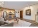 Open-concept living room with neutral tones, modern furnishings, and access to a kitchen at 400 Zang St # 1-105, Lakewood, CO 80228
