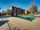 Community pool area featuring a covered pool and surrounding landscaping at 400 Zang St # 1-105, Lakewood, CO 80228