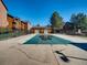 Community pool area with a covered pool, surrounded by well-maintained landscaping at 400 Zang St # 1-105, Lakewood, CO 80228