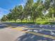 A street view of the neighborhood with mature trees providing shade on a sunny day at 400 Zang St # 1-105, Lakewood, CO 80228