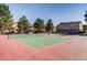 Tennis courts for residents with mature trees in the background of the community at 400 Zang St # 1-105, Lakewood, CO 80228