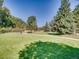 Landscaped walking path with green grass and trees at 400 Zang St # 1-105, Lakewood, CO 80228