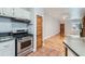 Kitchen boasts stainless steel appliances and white cabinets at 2528 N Gilpin St, Denver, CO 80205