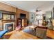 Living room features hardwood floors, exposed brick, and a fireplace at 2528 N Gilpin St, Denver, CO 80205