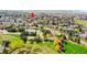 Aerial view of the community, pond, and playground with trees at 201 Wright St # 105, Lakewood, CO 80228