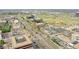An aerial view of the property shows bustling roads, nearby buildings, and a commercial area at 201 Wright St # 105, Lakewood, CO 80228