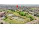 A scenic aerial view shows a park with ponds and lush greenery near the property location at 201 Wright St # 105, Lakewood, CO 80228