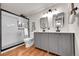 Updated bathroom featuring a dual sink vanity, modern mirrors, and walk-in shower with white subway tile at 201 Wright St # 105, Lakewood, CO 80228