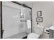 Updated bathroom featuring a stylish tiled shower with glass door and modern fixtures at 201 Wright St # 105, Lakewood, CO 80228