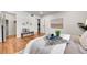 Bedroom with hardwood flooring, natural light, and view into a walk-in closet and entry hall at 201 Wright St # 105, Lakewood, CO 80228