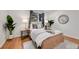 Well-lit bedroom with hardwood floors, large window and coordinated decor contributing to a relaxing ambiance at 201 Wright St # 105, Lakewood, CO 80228