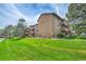 Well-maintained apartment building with manicured lawn and mature trees in a desirable location at 201 Wright St # 105, Lakewood, CO 80228