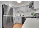 Updated kitchen features stainless steel appliances, light gray cabinetry, and a modern subway tile backsplash at 201 Wright St # 105, Lakewood, CO 80228