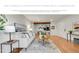 Inviting living room with modern furnishings, wood floors, and bright, open layout to the kitchen and dining area at 201 Wright St # 105, Lakewood, CO 80228