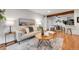 Open living space with hardwood floors seamlessly connects to dining area and kitchen at 201 Wright St # 105, Lakewood, CO 80228