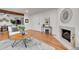 Inviting living room with hardwood floors and a cozy fireplace visible at 201 Wright St # 105, Lakewood, CO 80228