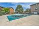 Community pool with safety cover, surrounded by well-maintained grounds at 201 Wright St # 105, Lakewood, CO 80228