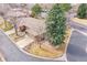 Aerial shot reveals a property showcasing mature trees, a brick home, and tiled roofing at 8040 W 78Th Way, Arvada, CO 80005