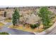 Aerial view featuring brick home, manicured lawn, mature trees, and a tranquil neighborhood setting at 8040 W 78Th Way, Arvada, CO 80005