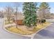 Aerial view of landscaped property with brick home, mature trees, and well-maintained yard and sidewalks at 8040 W 78Th Way, Arvada, CO 80005