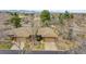 Overhead view displaying brick home, mature trees, tidy lawn, and ample parking space in residential area at 8040 W 78Th Way, Arvada, CO 80005
