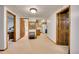 Finished basement area with an adjacent kitchenette, bathroom, and doorway at 8040 W 78Th Way, Arvada, CO 80005