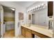 Bathroom featuring dual doors and a large mirror with vanity lighting at 8040 W 78Th Way, Arvada, CO 80005