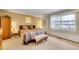 Comfortable bedroom featuring a queen-sized bed, neutral walls, and bright window at 8040 W 78Th Way, Arvada, CO 80005