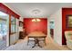 Elegant dining room with bold accent wall, chandelier, and sliding glass doors to outdoor patio at 8040 W 78Th Way, Arvada, CO 80005