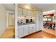 Bright kitchen bar with updated cabinets and view of dining room at 8040 W 78Th Way, Arvada, CO 80005