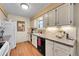Bright kitchen with updated appliances, tile backsplash, wood-look flooring and abundant cabinet space at 8040 W 78Th Way, Arvada, CO 80005