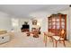 Comfortable living room showcasing a cabinet, chair, and large carpet, offering an open layout at 8040 W 78Th Way, Arvada, CO 80005
