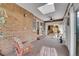 Relaxing sunroom featuring a brick wall, fan, and sun roof; a cozy place to relax at 8040 W 78Th Way, Arvada, CO 80005