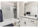 Bathroom featuring granite counters, modern fixtures, and tiled shower-tub that offers a clean aesthetic at 10080 E 160Th Pl, Brighton, CO 80602