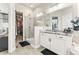 Modern bathroom with glass-enclosed shower, dual vanity with granite countertops, and access to a walk-in closet at 10080 E 160Th Pl, Brighton, CO 80602