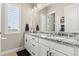 Bathroom featuring double sinks with a granite countertop, modern fixtures, and natural light at 10080 E 160Th Pl, Brighton, CO 80602
