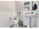 Cozy half bath featuring white wainscoting, and a classic pedestal sink at 10080 E 160Th Pl, Brighton, CO 80602