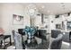 Formal dining room with chandelier, dark furniture, and view into kitchen at 10080 E 160Th Pl, Brighton, CO 80602