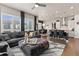 Open concept living space with a large sectional couch, seamlessly flowing to the dining area and kitchen at 10080 E 160Th Pl, Brighton, CO 80602