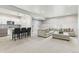 Open-concept living area with modern finishes, including a kitchenette, wet bar, and a comfortable seating area at 10080 E 160Th Pl, Brighton, CO 80602