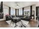 Cozy living room showcasing a large sectional, wood floors, and lots of natural light at 10080 E 160Th Pl, Brighton, CO 80602