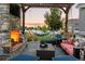 Backyard retreat with fireplace, TV, hammock and lounge chairs for outdoor relaxation at 10080 E 160Th Pl, Brighton, CO 80602