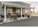 Covered porch with seating, a hammock and charming decor providing a relaxing outdoor space at 10080 E 160Th Pl, Brighton, CO 80602