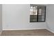 Neutral bedroom featuring a large window, carpet, and a white wall at 922 S Walden St # 101, Aurora, CO 80017