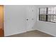 Cozy bedroom with beige carpet, a built-in closet, and a window with blinds at 922 S Walden St # 101, Aurora, CO 80017
