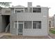Gray two-story condo with decks and well-maintained landscaping, with a gated private front yard at 922 S Walden St # 101, Aurora, CO 80017
