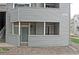 Condo exterior featuring a private patio with railings and sliding glass doors at 922 S Walden St # 101, Aurora, CO 80017
