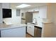 Kitchen with stainless steel appliances, white cabinets, and bright lighting at 922 S Walden St # 101, Aurora, CO 80017