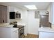 Updated kitchen with stainless steel appliances, white cabinets, and bright lighting at 922 S Walden St # 101, Aurora, CO 80017