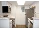 Updated kitchen with stainless steel appliances, white cabinets, and bright lighting at 922 S Walden St # 101, Aurora, CO 80017